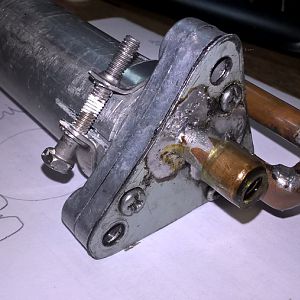 Вход и выход припаяны на отдельную пластинку, которая прикручена к насосу через картонную прокладку.